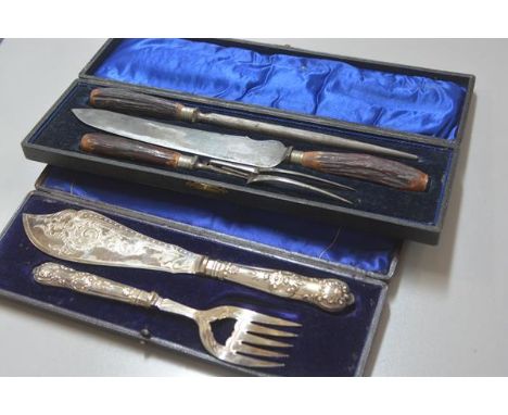 A pair of Edwardian Epns engraved fish servers complete with fitted case and an Edwardian stag's horn three piece carving set