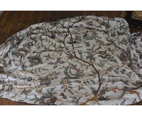 A crewelwork on cotton fabric piece, formed as a loose cover for a sofa, with panelled front, back and sides (front lower sea