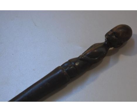 An African carved light wood seated figure walking stick (l.91cm)