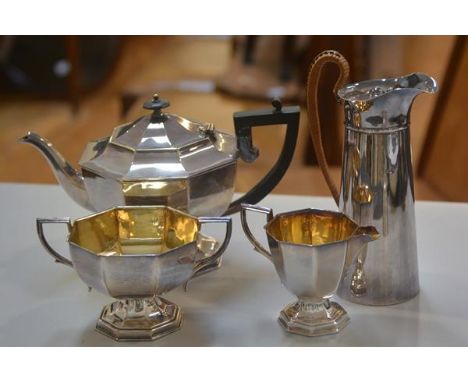 An Epns three piece panelled tea service complete with gilded tiered sugar and cream, and an Epns hot water jug with raffia c