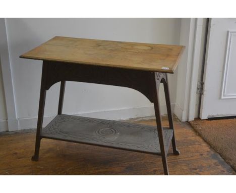 An Edwardian oak Arts &amp; Crafts style occasional table, the rectangular top with moulded edge and relief carved scrolling 