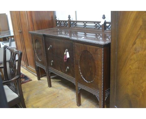 A late 19thc Chippendale design ledgeback sideboard with pierced gallery back, mounted with finials and relief carved shaped 