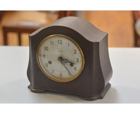 A 1930s Smiths Enfield brown bakelite chiming mantel clock with enamel dial, twin key apertures and arabic numerals, complete