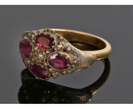 18 carat gold garnet and pearl set ring, with a central pearl and four garnets surround, ring size G