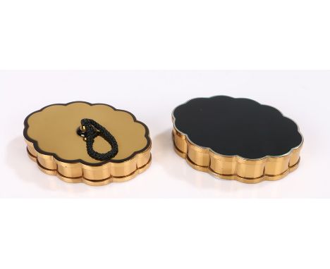 Two Volupte USA scalloped edged oval compacts in black enamel and gold tone, both with original powder puffs and pouches, one