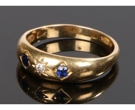 18 carat gold diamond and sapphire set ring, with a central diamond flanked by a sapphire to either side, ring size Q