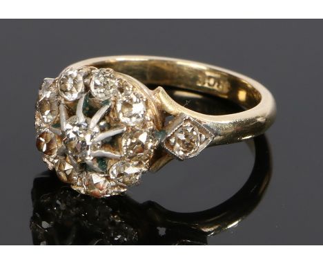 18 carat gold diamond set ring, with a central diamond raised above the diamond surround and a diamond to either shoulder, ri