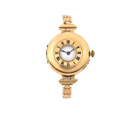 Ladies 9 carat gold half hunter style wristwatch, the white enamel dial with Roman numerals, the cover with central circular 