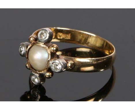 Victorian 18 carat gold diamond and pearl ring, with a central pearl and four round cut diamonds to the edge, ring size O