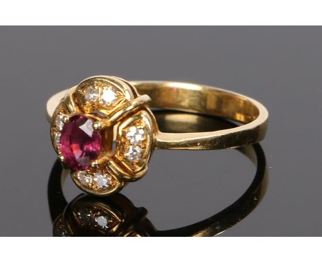 18 carat gold ruby and diamond set ring, with a central ruby and diamond surround, ring size P