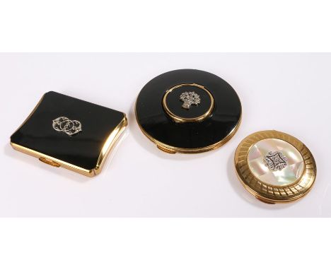 Three vintage Kigu compacts: one round black enamel and marcasite 'Locet top' compact with a lidded centrepiece that lifts up