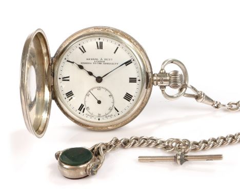 Kendal &amp; Dent silver half hunter pocket watch, the engine turned case with black enamel roman numerals, the signed white 