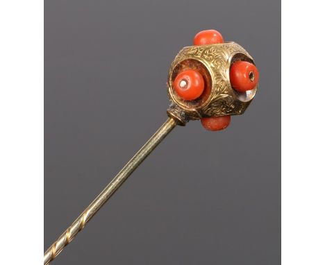 Victorian coral and yellow metal stick pin, the ball top with coral beads protruding from recesses, 8cm long