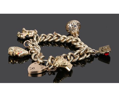 9 carat gold charm bracelet, with a horse head, bell, lamp, squirrel, dog and padlock clasp, 74 grams