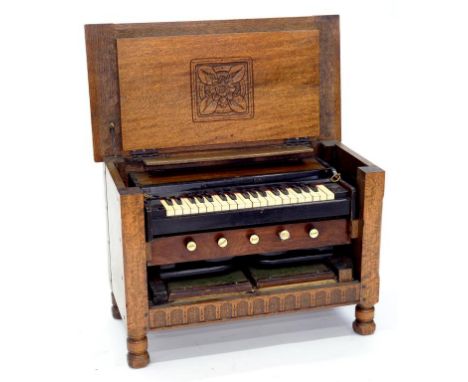 A 19TH C OAK PORTABLE HARMONIUM, FITTED IN A LATER CARVED OAK CHEST