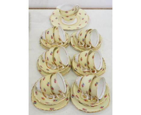 A COLCLOUGH PRIMROSE GROUND BONE CHINA TEA SERVICE, DECORATED WITH SCATTERED ROSES