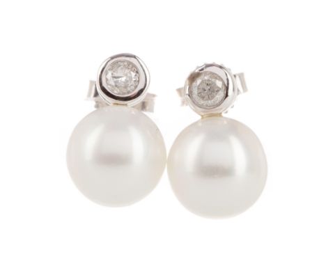 PAIR OF PEARL AND DIAMOND STUD EARRINGS, the spherical pearls to a diamond set post, the round brilliant cut diamonds totalli