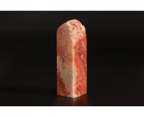 A CARVED SOAPSTONE 'LOTUS' SEAL
The slender rectangular seal carved to one side with large lotus leaves and flowers to the to