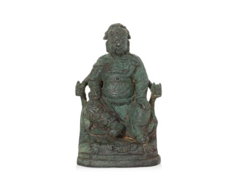 A BRONZE FIGURE OF GUANDI SEATED ON A HORSEHOE THRONE Ming dynasty, modelled with eyes closed in pensive expression, seated o