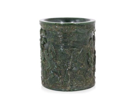 A LARGE CARVED SPINACH JADE EIGHT IMMORTALS BRUSH POT Late Qing, carved in deep relief with a continuous scene of eight immor