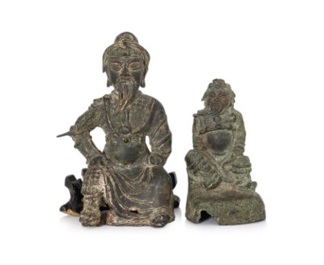 TWO SEATED BRONZE FIGURES OF GUANDI Ming dynasty, the taller example modelled wearing robe over armour, with later wooden sta