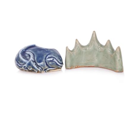 AN OX FIGURE PORCELAIN WATER POT AND A CELADON BRUSH HOLDER
A blue glazed water pot modelled as a curled-up sleeping ox, and 