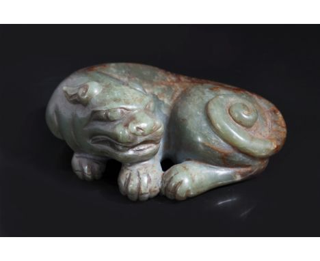 A JADE CARVING OF LION
A spinach green and russet jade lion modelled seated curled around itself, its tail similarly curled
9
