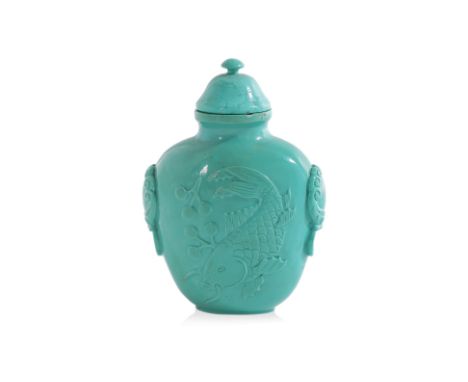 A CARVED TURQUOISE SNUFF BOTTLE
Carved in shallow relief to each side with a swimming koi fish, between mask handles
4.5cm hi