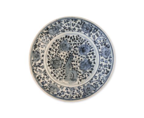A LARGE BLUE AND WHITE DISH
Ming dynasty, densely decorated four central florets surrounded by flowing vines, six panels of s