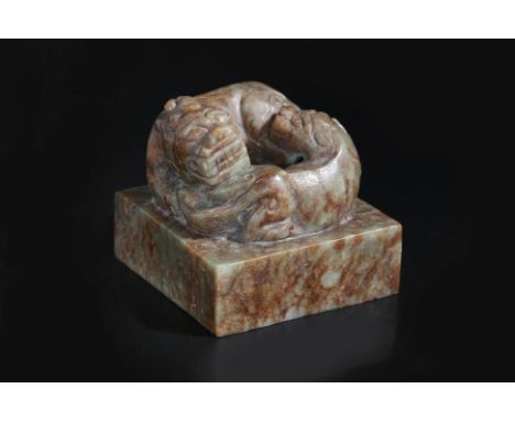 A LARGE JADE SEAL WITH CARVING OF MYTHICAL BEAST
Green and russet jade square seal with two conjoined feline beasts, un-engra