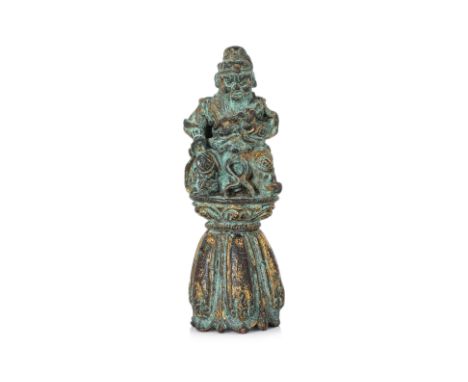 A SMALL GILT BRONZE FIGURE OF A BODHISATTVA Probably Tang dynasty, modelled wearing robe and sitting atop an attached conical