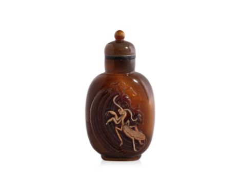 AN AGATE CAMEO 'CRICKET' SNUFF BOTTLE
Rectangular with rounded sides, the fore-section decorated in relief carved white toned