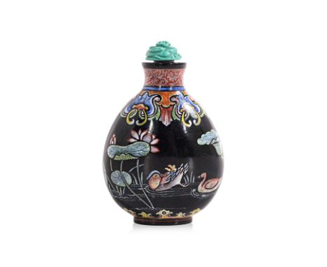 AN ENAMELLED BLACK GLASS 'LOTUS POND' SNUFF BOTTLE
Opaque black glass decorated in scene of two ducks in pond with lotus, fou