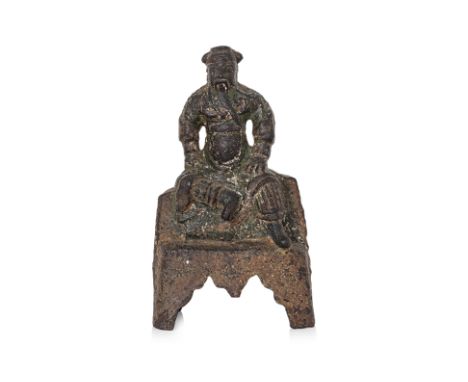 A SEATED BRONZE FIGURE OF GUANDI, WITH INSCRIPTION Ming dynasty, modelled seated on ledge with right leg raised, both arms re