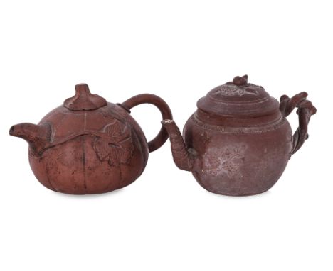 TWO YIXING POTTERY TEAPOTS WITH COVERS
One example decorated in plum blossom and bamboo with twisted branch handle and bamboo