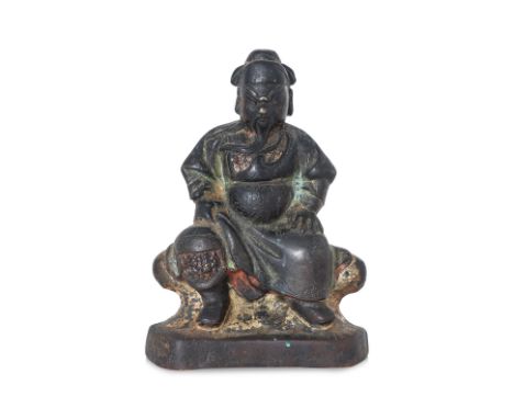 A SEATED LACQUERED BRONZE FIGURE OF GUANDI Ming dynasty, modelled wearing floral decorated robe, with traces of red, green an