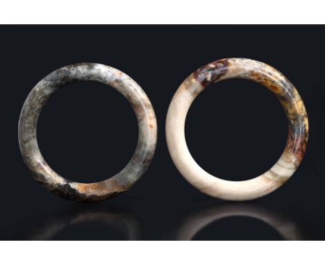 TWO JADE BANGLES
Two rounded circular bangles in russet and beige toned jade
9.6cm and 9.8cm diameter
From the estate of Dr. 