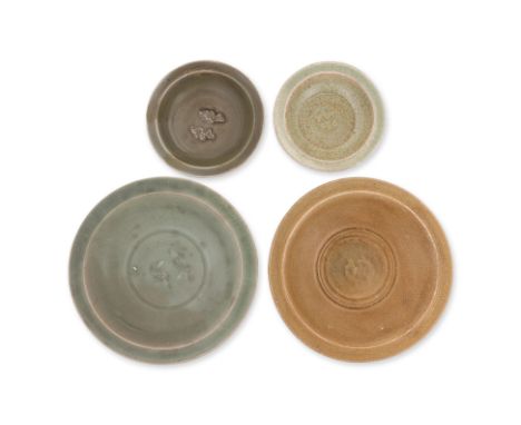 FOUR LONGQUAN CELADON 'TWIN FISH' DISHES
Song-Ming dynasty, two larger dishes, one with gaze burnished orange-brown with ungl