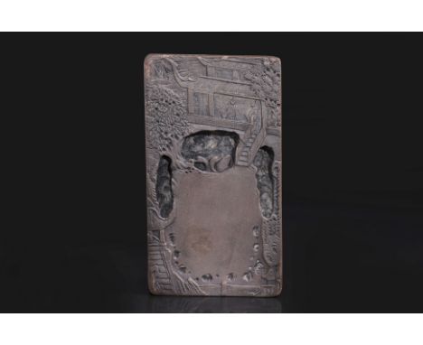 A CARVED RECTANGULAR DUAN INK STONE
Decorated in relief scenes to all six sides, the top showing a pavilion with deep carved 