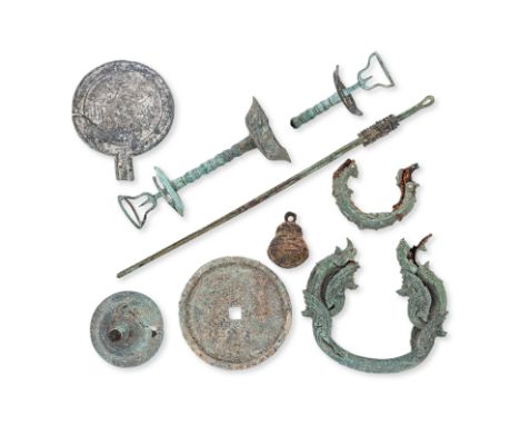 AN ASSORTMENT OF BRONZE OBJECTS
Circa 10th century and later, two Khmer part-palanquin hooks, a Southeast Asian mirror, a pai