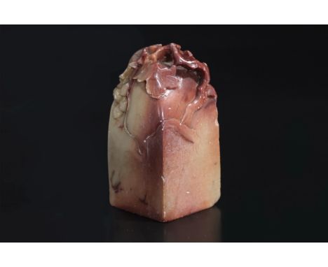 A CARVED SOAPSTONE FRUITING VINE SEAL
Square section, the top carved to all sides with trailing vines and bunches of grapes, 