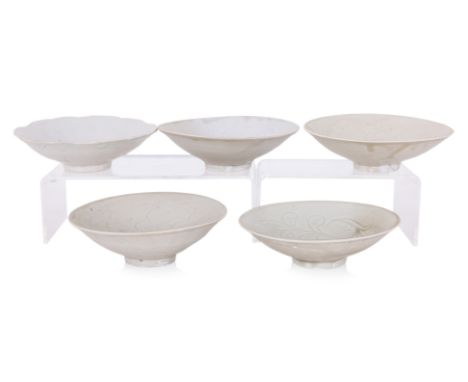 A GROUP OF OF FIVE COMBED QINGBAI BOWLS
Song/Yuan Dynasty, four examples of a similar type with pale grey-green glaze combed 