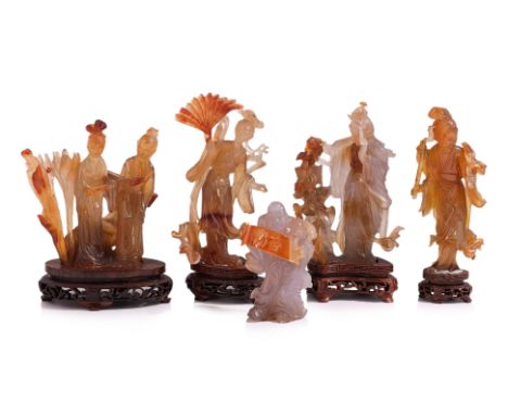 A GROUP OF FIVE CARVED AGATE FIGURES
Comprising of four orange-brown and grey toned standing ladies with reticulated wooden s