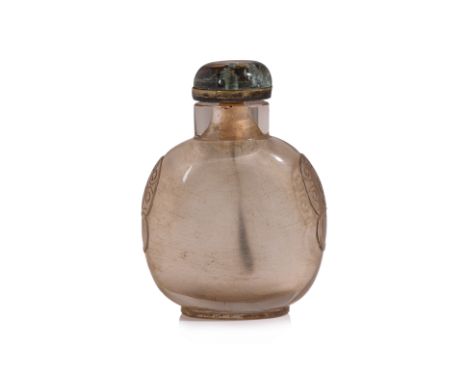 A CLEAR CRYSTAL SNUFF BOTTLE
A large compressed oviform bottle in transparent quartz, decorated in carved mask and ring mount
