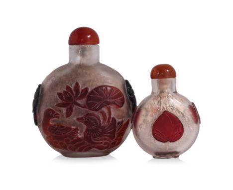 TWO OVERLAID GLASS SNUFF BOTTLES
One large two colour example, decorated with a pair of mandarin ducks in a lotus pond, the r
