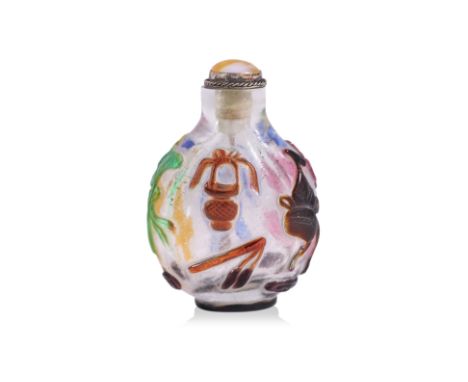 A MULTI-COLOURED OVERLAY AND CLEAR GLASS SNUFF BOTTLE
Circular form bottle decorated in various relief carved emblems, 19th/2