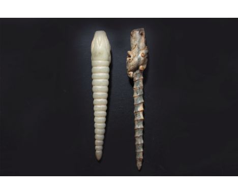 TWO CARVED JADE HAIRPINS
A writhen form celadon example with dragon head, and dark-green and beige toned example of similar f