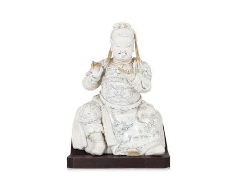 A DEHUA FIGURE OF GUANDI
Circa 17th/18th century, heavily potted, modelled sitting with legs apart, wearing dragon decorated 