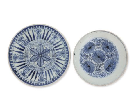 TWO BLUE AND WHITE PLATES
A Ming dynasty chrysanthemum decorated plate with five central florets surrounded by curling vines,
