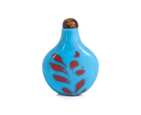 AN OPAQUE BLUE AND RED GLASS SNUFF BOTTLE
Flattened spade form bottle with tapering neck, decorated in red splashes to both s
